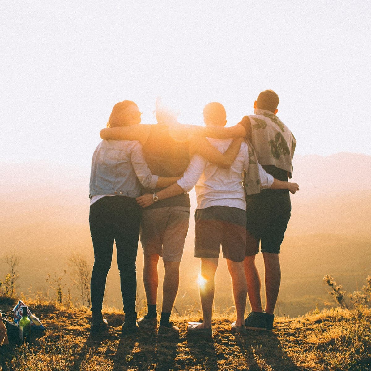 Friends with arms around each other's shoulders